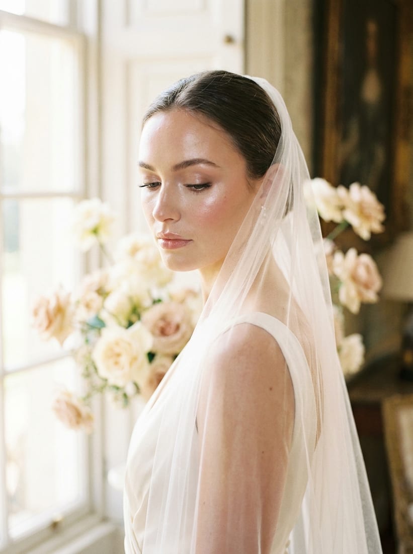 A bride with soft, luminous bridal makeup and a veil